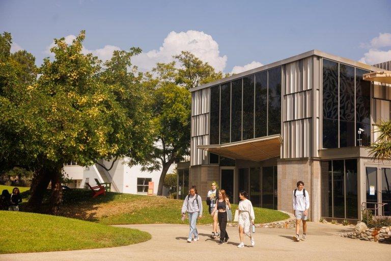 Students walk past the exterior of Benson Auditorium.